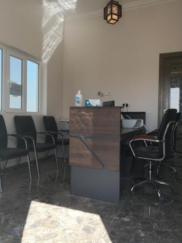 an empty office with chairs and a desk with at Almorouj Farm inn - Bidiya in Bidiyah