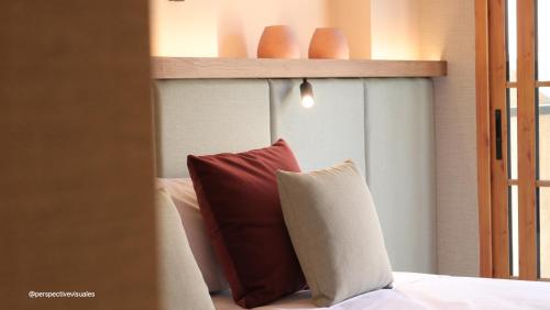 a bedroom with a bed with a red pillow at JovA Hotel Boutique in El Campello