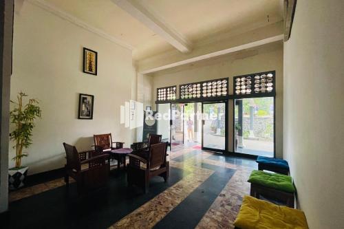 a living room with a dining room table and chairs at Langko 48 RedPartner in Tanjungkarang