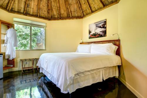 a bedroom with a bed and a window at Volcano Eco Retreat by Heart Core Hotels - Adults Only in Mountain View
