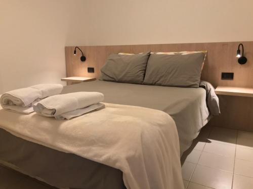1 cama con 2 almohadas en una habitación en AYACUCHO APART. en Córdoba