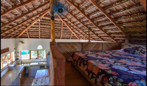 a bedroom with a bed and a desk in a room at Pura Vida Tofo Beach Houses in Praia do Tofo