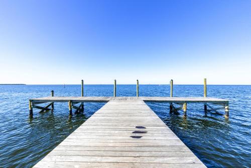 a wooden pier in the middle of the water at Come Stay Where the Dolphins Play! in Ruskin