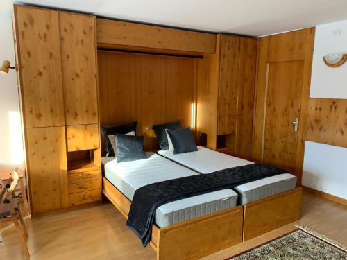 a bedroom with a large bed with wooden walls at Cervinia Apartment 2112 in Breuil-Cervinia