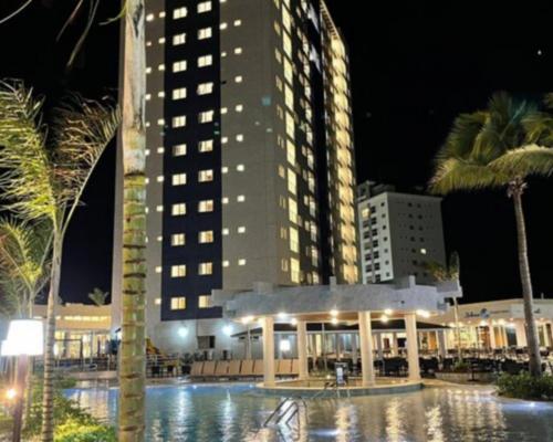 a large building with a pool in front of it at Salinas Exclusive Resort in Salinópolis