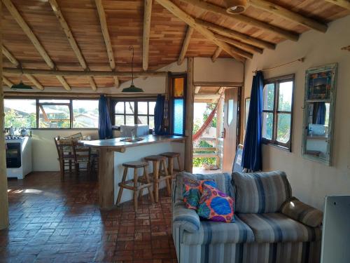 a living room with a couch and a bar at Pousada Gopak in Praia do Rosa