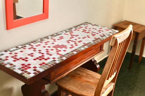 a table with a chessboard on top of it at Colonial Hotel in Ilhabela