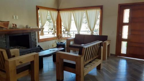 a living room with a couch and a fireplace at Cabaña Verito in Mazamitla