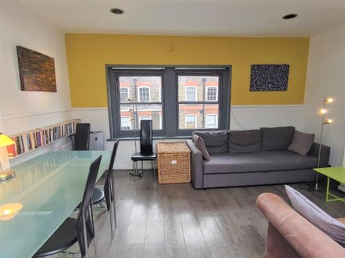 salon z kanapą i szklanym stołem w obiekcie Stylish apartment near Carnaby Street w Londynie