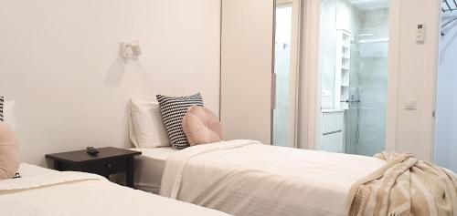 two beds in a room with a mirror at HD Mogán Canal Apartments in Puerto de Mogán