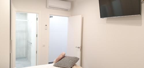 a room with a mirror and a chair with a pillow at HD Mogán Canal Apartments in Puerto de Mogán
