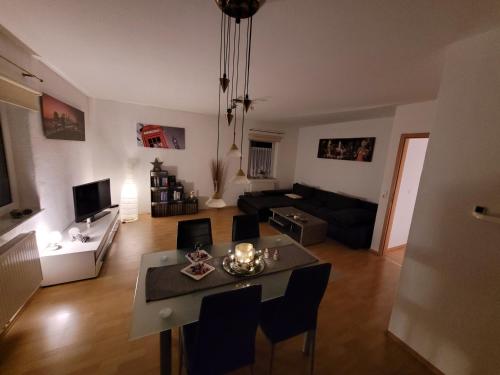 a living room with a table and a couch at Ferienwohnung mit Terrasse für bis zu 4 Personen in Balve
