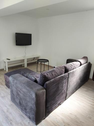 a large leather couch in a living room with a tv at Payrac LOT in Payrac
