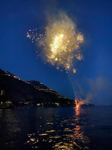 a firework display over the water at night at Il Profumo dei Fiori in Praiano
