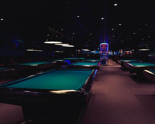 a row of pool tables in a billiard room at City Apartment Fully Furnished - Lillestrøm-Strømmen in Lillestrøm