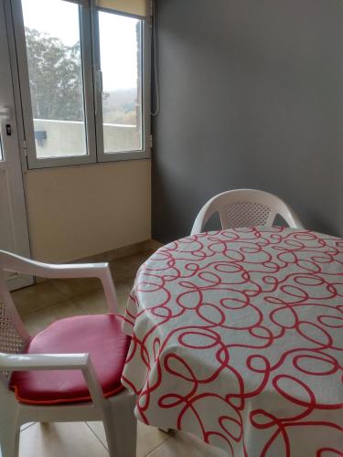 a dining room with a table and two chairs at La Casa de Liber in Tandil