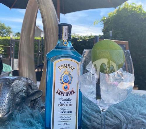 a bottle of gin sitting next to a wine glass at Hotel Ten Lande in Beernem