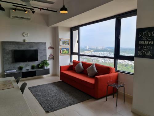 a living room with a red couch and a large window at D'Kroll Tamarind Cyberjaya 1 Bedroom Premium Suite with Netflix in Cyberjaya