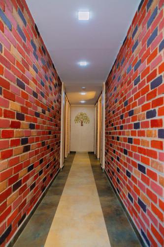 a corridor of a brick wall with a hallway at Laughing Waters Fine Stay in Kuttālam