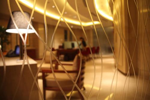 a view of a living room with a table and a lamp at Trident Bandra Kurla in Mumbai