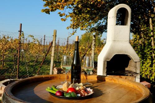 a table with a bottle of wine and a plate of food at Rubin in Doba