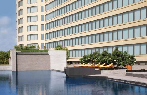 a building with a pool of water in front of it at Trident Bandra Kurla in Mumbai