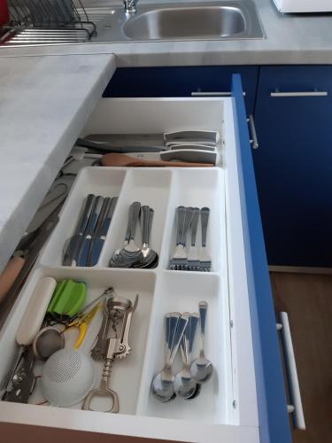 a kitchen drawer filled with utensils and a sink at Apartmán Horní Lipová č. 3 in Lipova Lazne