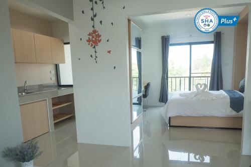 Ein Bett oder Betten in einem Zimmer der Unterkunft Sirimunta Hotel Chiang Rai Suite & Residence