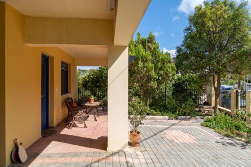 a porch of a house with a table and chairs at Μονοκατοικία στο Παλιόκαστρο in Palaiokastro