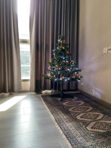 a christmas tree in the corner of a room at Politan Breeze, Chaophraya River view in Ban Sai Ma