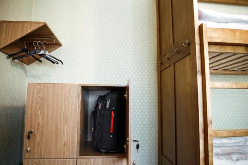 a black backpack is inside of a closet at Sweet Home Hostel in Chernivtsi