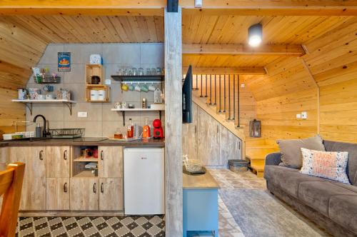 a kitchen and living room in a log cabin at Brvnare Lovor in Krajevi