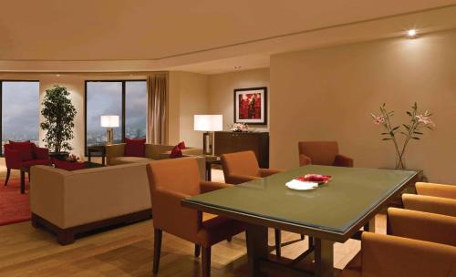 a living room with a table and chairs at Trident Bandra Kurla in Mumbai