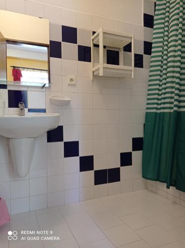 a bathroom with a sink and a mirror at Penzion Poslední míle in Milovy