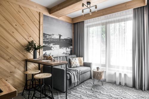 a living room with a couch and a table at Willa pod Orłem - Zakopane in Zakopane