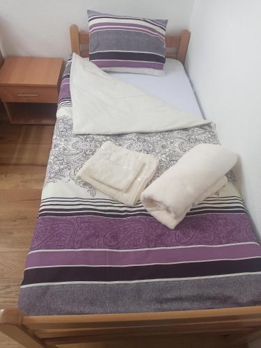 a bed with two pillows on top of it at Apartman Sky Banja Vrujci in Gornja Toplica