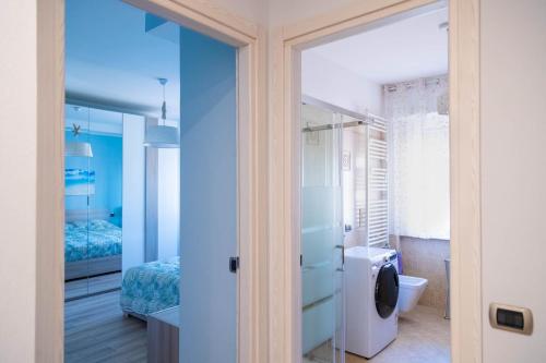 uma casa de banho com paredes azuis e um WC e um lavatório. em SAREMY - Home Sweet Home em Paderno Dugnano