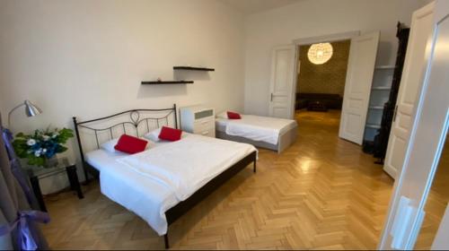 a bedroom with two beds with red pillows at Apartment HVIEZDKO in Bratislava