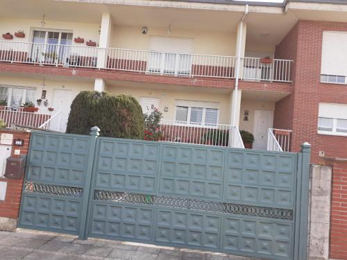 a blue fence in front of a house at Casa Rotella in Puente San Miguel