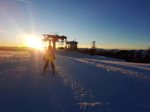 a person on skis in the snow at sunset at Residence Alba Montis in Bad Kleinkirchheim