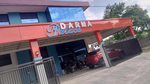 a parking garage with motorcycles parked outside of it at Darma Palace Syariah in Padang