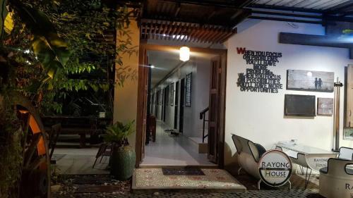 an entrance to a building with a door open at Rayonghouse Resort in Rayong
