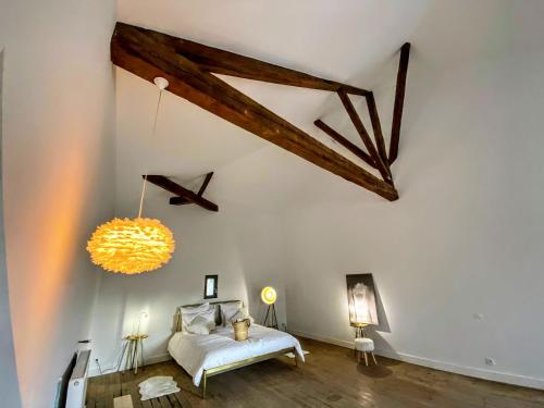 a room with a bed and a chandelier at MY BOUTIQUE GUESTHOUSE - Fabulous Suites 10 Min A7 - in Anneyron