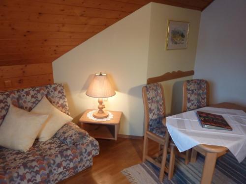 a room with a couch and a table with a lamp at Haus Lechthaler in Aflenz Kurort