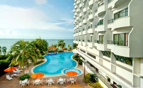 an aerial view of a hotel with a swimming pool and the ocean at Flamingo Hotel by the Beach, Penang in George Town