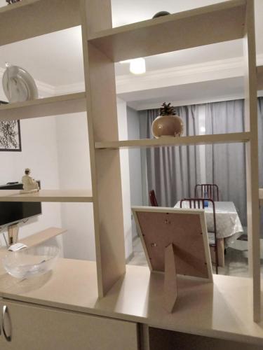 a room with a table with a mirror on a shelf at Izmir Apartment in Baku