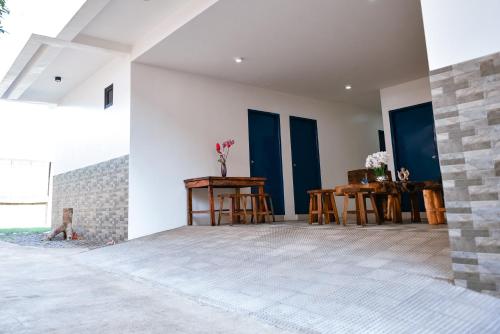 a room with white walls and a table and chairs at Hotel Don Raul in Dagupan