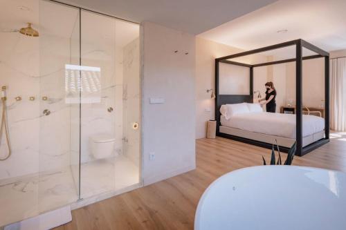 Ένα ή περισσότερα κρεβάτια σε δωμάτιο στο Hotel Palau Macelli & Spa