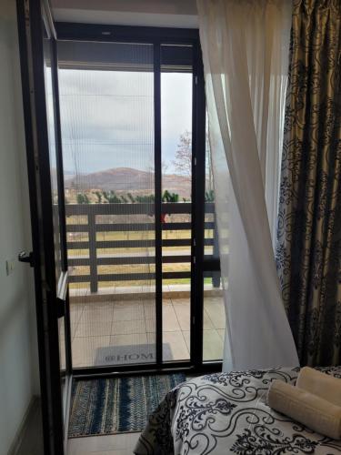 a bedroom with a door open to a balcony at Casa Aryana, adults only in Bran