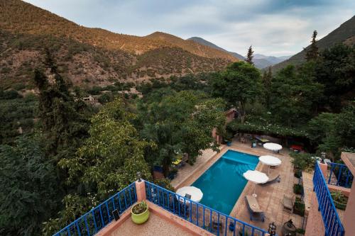 a view of a swimming pool with mountains in the background at Auberge le Maquis in Aghbalou